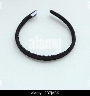 black silk hair hoop. silk ribbon isolated on white. Flat lay Hairdressing tools and accessories as Hair ring or hair hoop Stock Photo