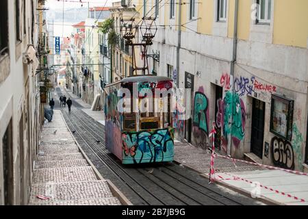 The famous Bica tram covered in graffiti, Bairro Alto district, Lisbon, Portugal Stock Photo