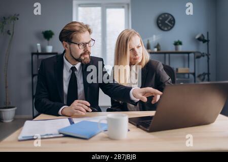 Two managers working together on computer at office Stock Photo