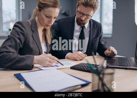 Two mature partners working together on common project. Stock Photo