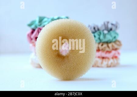 sponge and Lot of Colorful silk Scrunchies on white. Luxury Hairdressing tools and accessories. Hair Scrunchies, Elastic HairBands, Bobble Sports Stock Photo