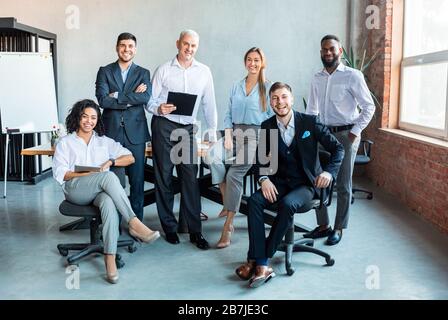 Group Of Successful Business People Posing At Workplace In Office Stock Photo
