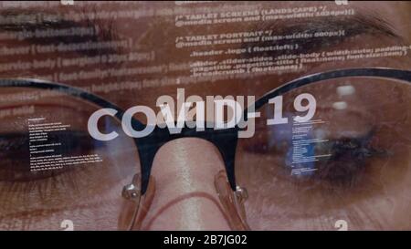 COVID-19 text on background of female software developer Stock Photo