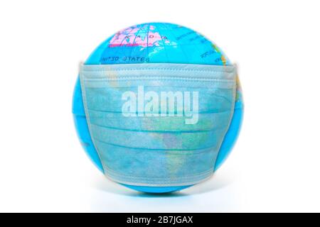 disposable face mask on a sick world globe isolated on white background. Concept of epidemic flu and pandemic emergency worldwide for COVID 19 Stock Photo
