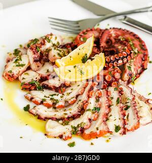 Octopus carpaccio on white background. Mediterranean food, Organic Healthy eating. Stock Photo