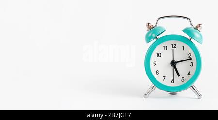 Turquoise alarm clock on white background. Banner, copy space. Stock Photo