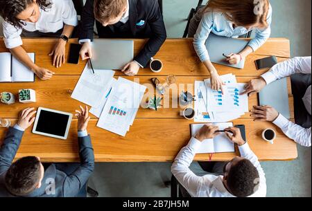 Mixed Business Team Working Sitting At Table In Office, Above-View Stock Photo