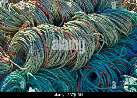 Coils of fiber rope to anchor lobster traps piled on the wharf in Saint Martins New Brunswick Canada. Stock Photo