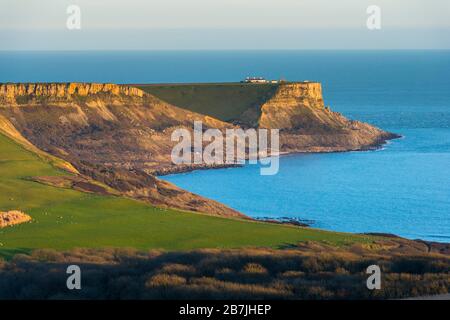 Kimmeridge, Dorset, UK.  16th March 2020.  UK Weather.   St Aldhelm’s Head viewed from Swyre Head near Kimmeridge on the Jurassic coast of Dorset shortly before sunset after a day of warm sunshine and clear blue skies.  Picture Credit: Graham Hunt/Alamy Live News Stock Photo