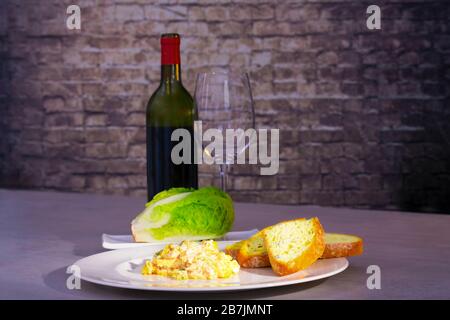 Scrambled eggs with bread and fresh lettuce Stock Photo