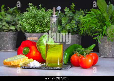 Olive oil with salt and assorted delicious vegetables Stock Photo
