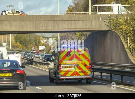 TAFFS WELL, CARDIFF, WALES - NOVEMBER 2018: Ambulance in the fast lane of a trunk road at Taffs Well on an emergency call with blue lights flashing Stock Photo
