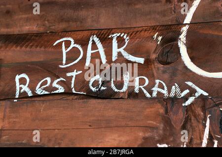 Restaurant bar sign painted on wooden board Stock Photo