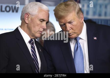 Washington, United States. 16th Mar, 2020. President Donald Trump talks to Vice President Mike Pence as they arrives to deliver a briefing with members on the Coronavirus Taskforce on the COVID-19 Coronavirus pandemic hitting the United States and the world, in the Brady Press Briefing Room of the White House on March 16, 2020 in Washington, DC Photo by Oliver Contreras/Pool Credit: UPI/Alamy Live News Stock Photo