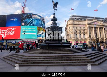 London, UK. 16th March 2020. Corona virus: The statue of Eros at Piccadilly Circus, normally a focal point for visitors to London is uncommonly quiet as people stay away from the city centre. Stock Photo