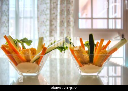 Salad of carrot sticks, cucumber, celery and corn on a delicious cream. A tasty and healthy dish ideal for everyone, especially for vegetarians. Stock Photo