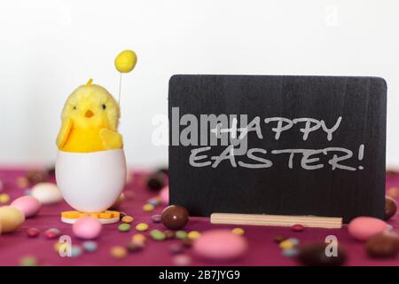 Decorative chick and blackboard with the text Happy Easter Stock Photo