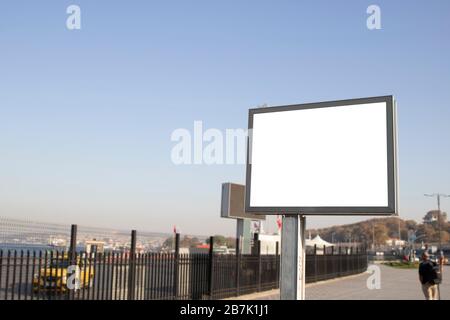 Empty rectangular bilboard. Photographed on the edge. Walking people. Stock Photo