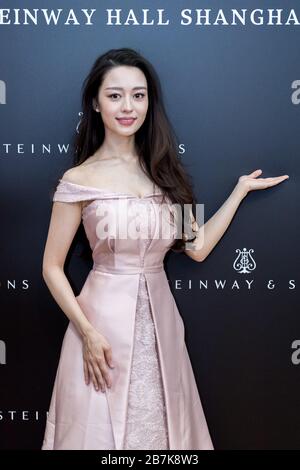 Germany pianist Gina Alice, the wife of Chinese concert pianist Lang Lang, shows off beauty with pink dress at the opening ceremony of Steinway Hall S Stock Photo