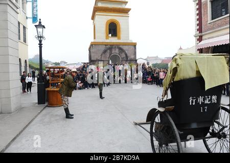 --File--Visitors watch a performance at the Hongkong and Guangzhou Street at Hengdian World Studios  in Dongyang city, east China's Zhejiang province, Stock Photo