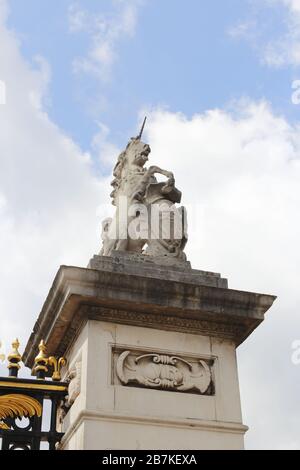 London, UK - May 11, 2019: A stone statue of unicorn on the gate of Buckingham Palace Stock Photo