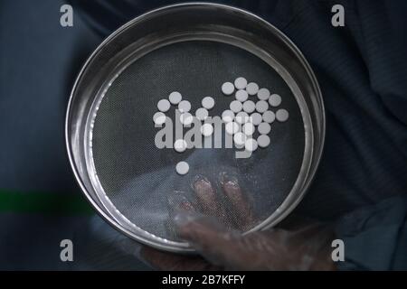 --File--In this undated and unlocated photo, a person shows Arbidol hydrochloride pills in China. Stock Photo