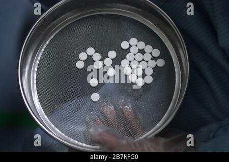 --File--In this undated and unlocated photo, a person shows Arbidol hydrochloride pills in China. Stock Photo