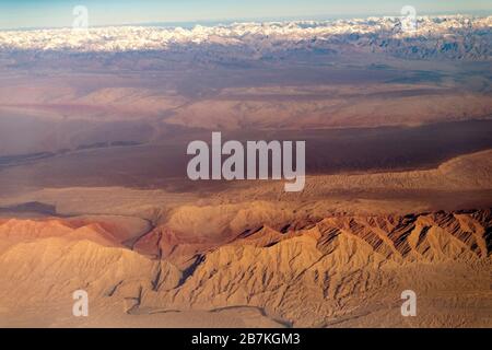 --FILE--An aerial view of the Taklamakan Desert, China's largest and world's 10th largest desert, with mountains whose tops are covered by snow, in Ka Stock Photo