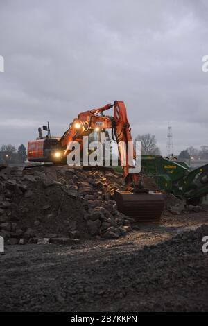 CHIÈVRES, Belgium -- Workers assigned to a private Belgian company, crush the concrete blocks from the demolition of old roads in order to recover these for new projects at Chièvres Air Base, Belgium, Feb. 5, 2020. (U.S. Army photo by Pascal Demeuldre, Training Support Battalion Benelux) Stock Photo