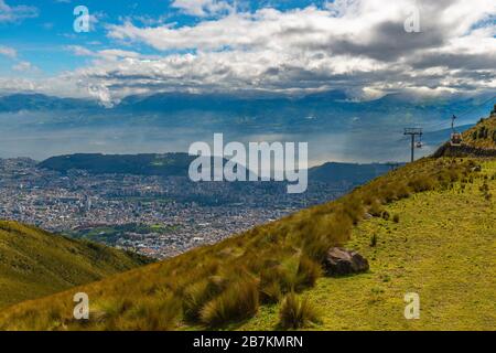 Quito cityscape with its cable car called Teleferico seen from the Pichincha volcano, Ecuador. Stock Photo