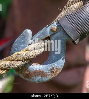 A metal hook isolated attached to a tick rope conceptual image
