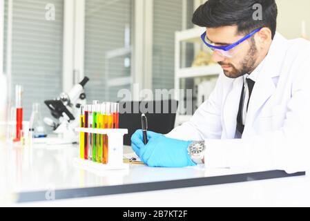 Man doctor as male scientist doing some research working conduct experiments in modern laboratory / Scientists in lab biochemistry genetics forensics Stock Photo