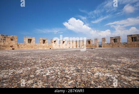 The flat roof of the keep tower surrounded by the defensive battlements. Kolossi Castle. Kolossi. Cyprus Stock Photo
