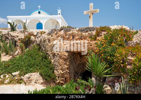 The view of small old catacomb church of St. Thekla (Agia Thekla) and the nice new one on  the rocky ledge. Ayia Napa. Cyprus Stock Photo