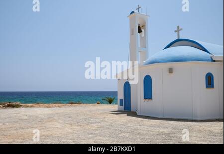 The nice new white and blue church of St. Thekla (Agia Thekla) on the rocky ledge over sea. Ayia Napa. Cyprus Stock Photo