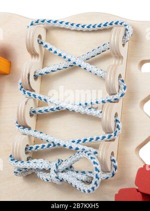 Close-up of lacing on a wooden panel of a toy Stock Photo