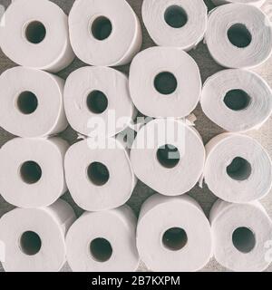 Toilet paper rolls background top flat view of many open rolls, square crop. Stock Photo