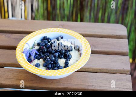 Closeup shot of a Semolina dessert with blueberries on a wooden table Stock Photo