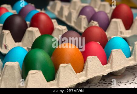 Multicolored painted Easter eggs in cardboard container Stock Photo