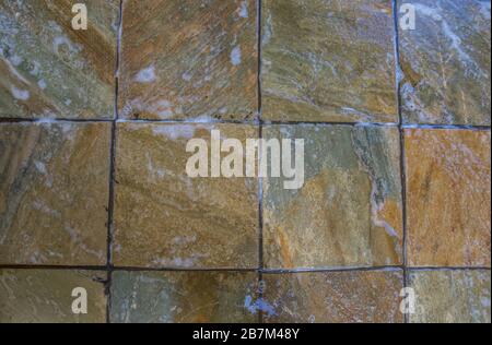 Wet earth stone coloured tiles full frame image for background use with copy space Stock Photo