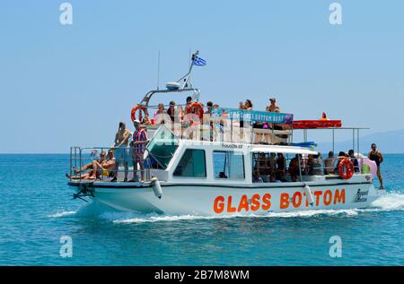 Tourists on a glass bottom boat in Anissaras a tourist attraction in Crete the largest and most populated o Stock Photo