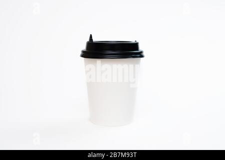 Coffee in a cardboard cup on a white background isolation. Top view, flat lay Stock Photo