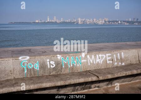 Atheist grafitti, 'God is Man-Made', painted on the embankment at Marine Drive, a boardwalk along the Arabian Sea in Mumbai (Bombay), India Stock Photo