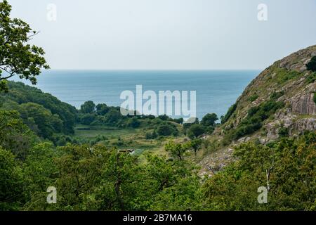 Hammershus, Bornholm / Denmark - July 29 2019: Valley with Baltic Sea in the back. Stock Photo