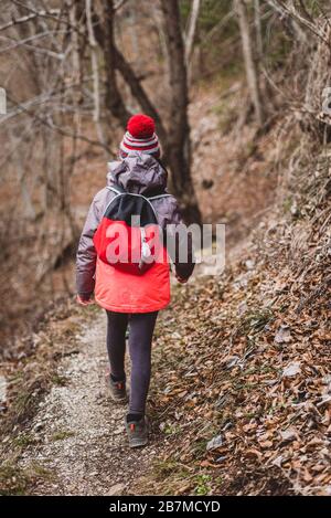 Children hiking in the mountains or woods on family trip. Active family, parents and children mountaineering in the nature. Kids are walking in woods Stock Photo