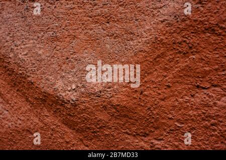Grunge red wall texture. Beautiful red textured stucco on the wall. Background from red stucco. Cement Red Stock Photo