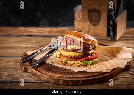 Set of hamburger beer and french fries. A standard set of drinks and food in the pub, beer and snacks. Dark background, fast food. Traditional america Stock Photo