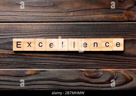 Excellence word written on wood block. Excellence text on wooden table for your desing, concept.