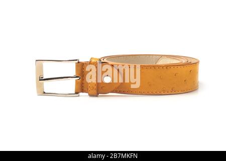 Rolled yellow leather belt isolated on white background Stock Photo
