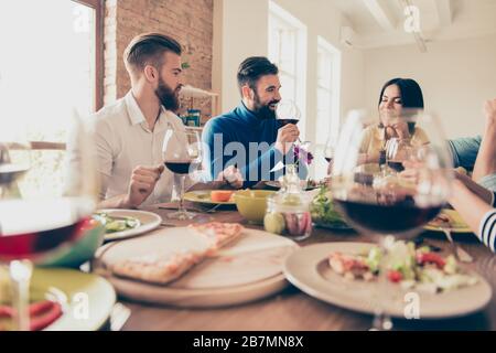 Cklose up of table with dishes at the party. Youth is having drinks with snacks and enjoy their communication Stock Photo